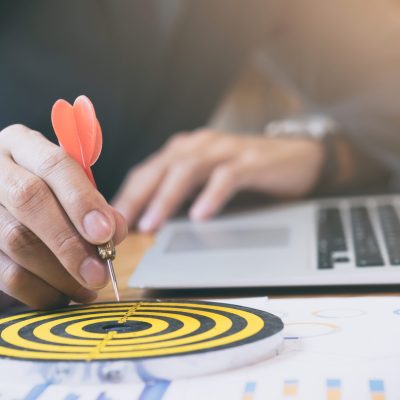 Business strategy success target goals. Businessman holding red dart push on target. Business strategy planning success target goals. Business development concept
